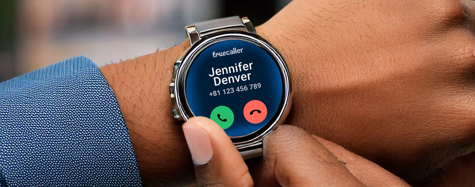 Image with a person with a smartwatch on their wrist showing an incoming call from Truecaller